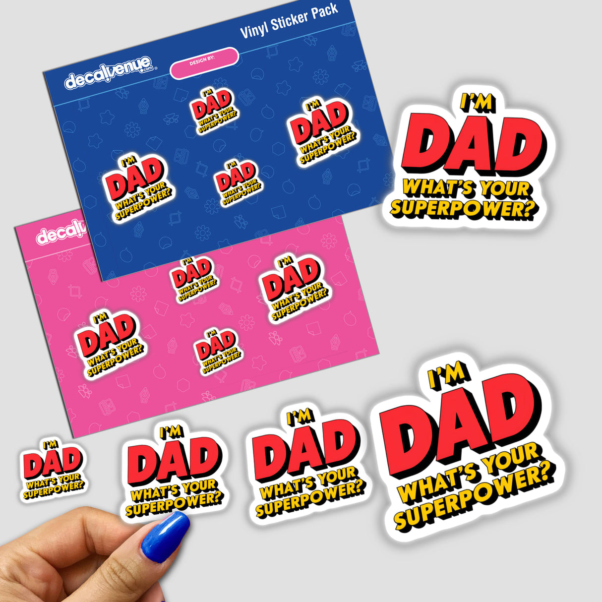 Hand holding a sticker pack with I'm Dad, What's Your Superpower? prominently featured, showcasing unique designs available as stickers or digital artwork from Decal Venue.