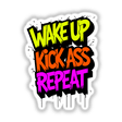 Wake Up Kick Ass Repeat Funny Quote sticker featuring bold typography on a black background, perfect for personalizing items and inspiring motivation.