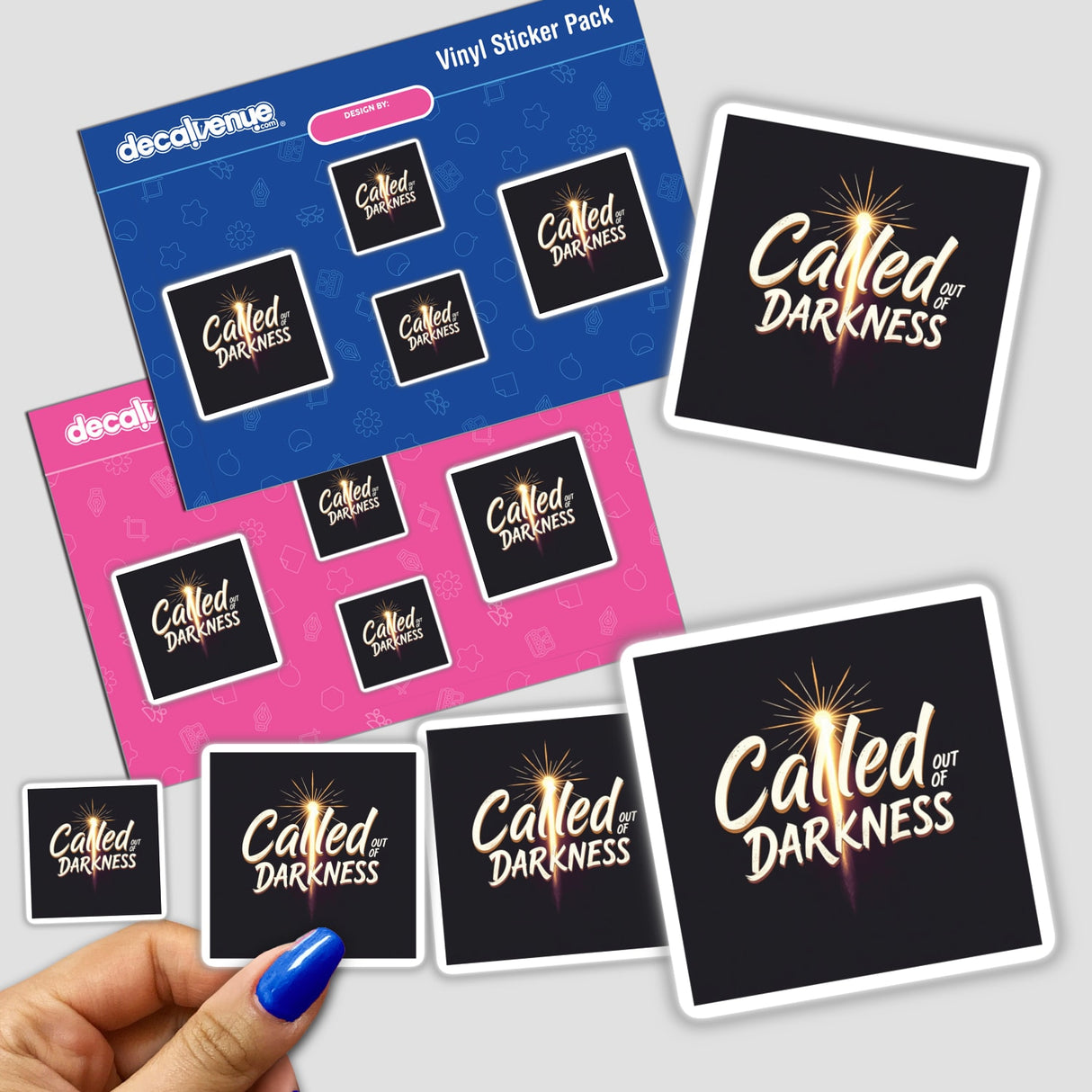 Hand holding 'Called Out of Darkness' sticker pack, featuring Christian Anti-Halloween designs, part of Decal Venue's unique sticker and digital art collection.