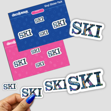 Hand holding SKI multiple locations stickers, showcasing white letters on a blue and pink background, reflecting Decal Venue's unique vinyl sticker collection.
