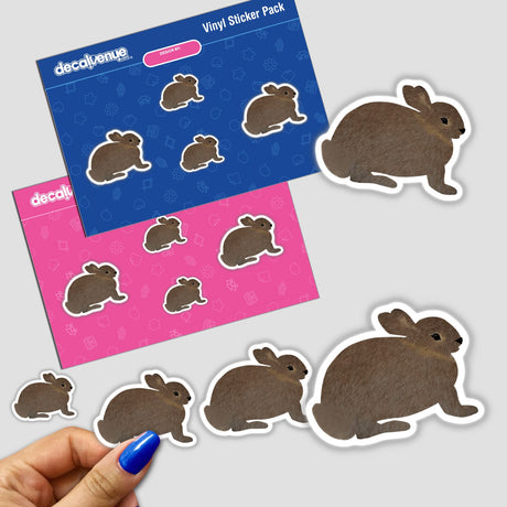 Hand holding stickers featuring cartoon-style brown bunny rabbits with white outlines, available as stickers or digital artwork from Decal Venue.