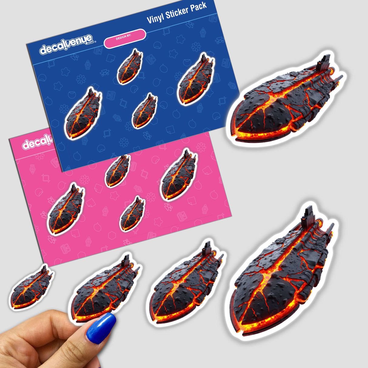 Molten Lava Spaceship sticker held by a hand with blue nail polish, displaying intricate design elements, available as both a sticker and digital artwork, representing Decal Venue's unique offerings.