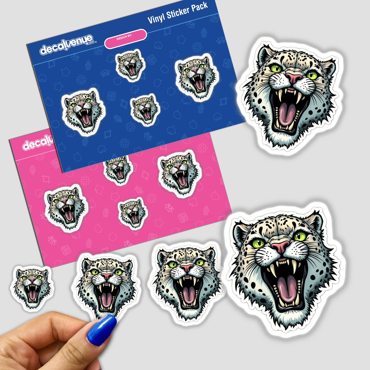 Hand holding an Onça Parda sticker pack featuring a black and white cheetah face. Available as stickers or digital artwork.
