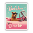 Barbiebara Dream Life Sticker or Clipart showcasing a cute capybara in a pink convertible, wearing sunglasses, as part of a playful Barbie parody design. Available with commercial rights.