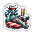 Cartoon of Statue of Liberty holding a beer, sitting on an inflatable pool, titled Statue of Liberty American Flag Float Merica. Available as stickers or digital artwork from Decal Venue.