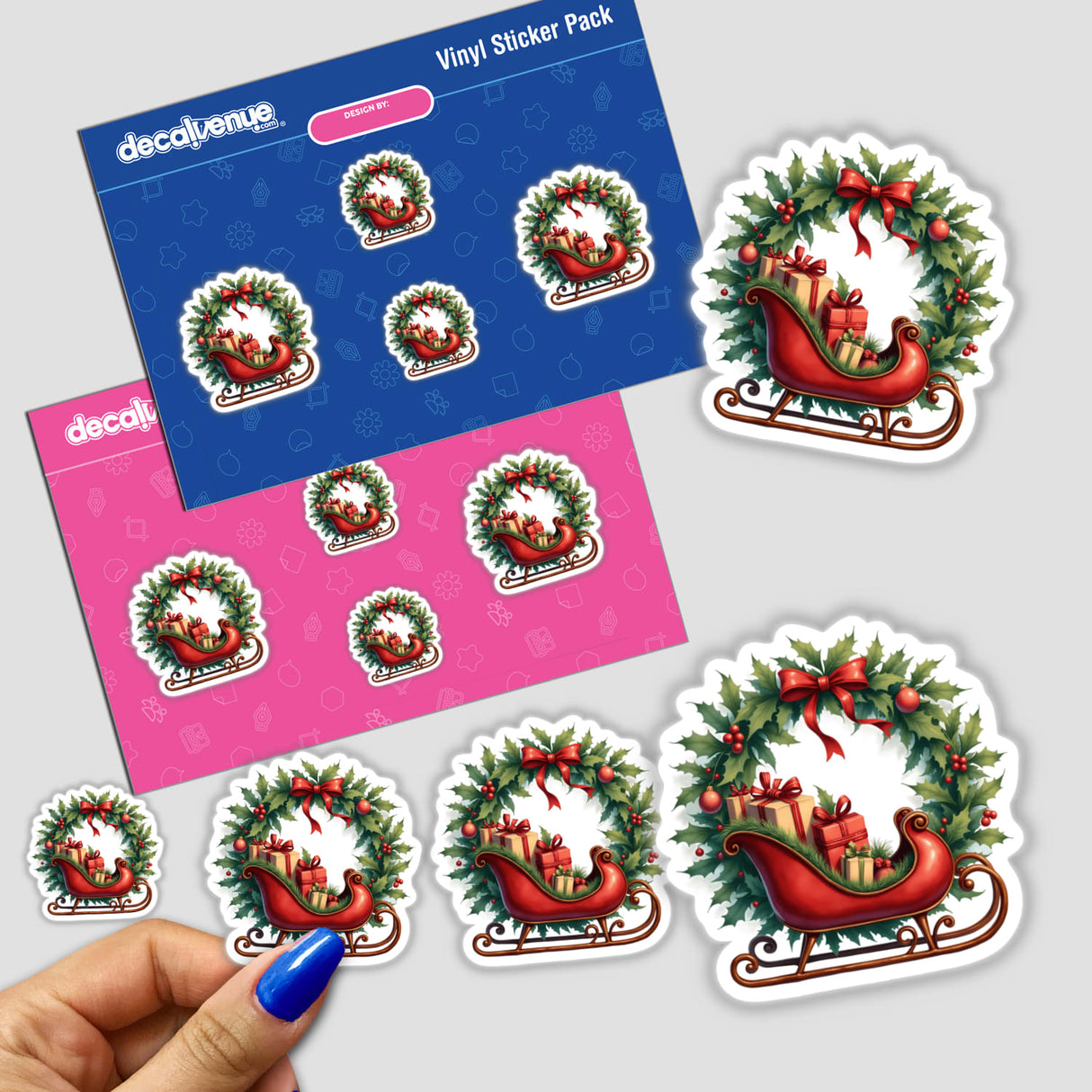 Vintage Sleigh with Presents in a Christmas Wreath sticker, featuring a hand holding the festive design, ideal for holiday crafts from DecalVenue's unique collection.