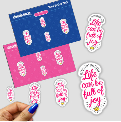 Life Can Be Full Of Joy Motivational Quote stickers featuring bold text, displayed on a surface with a hand holding them, available as unique vinyl stickers or digital artwork from Decal Venue.