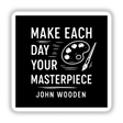 Make Each Day Your Masterpiece Sticker or Clipart features a black and white sign with white text, a paint palette, and knife drawings. Available as stickers or digital artwork with commercial rights.
