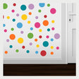 Vibrant polka dot wall decals in various sizes and colors surrounding a white door, creating a playful and decorative wall design.