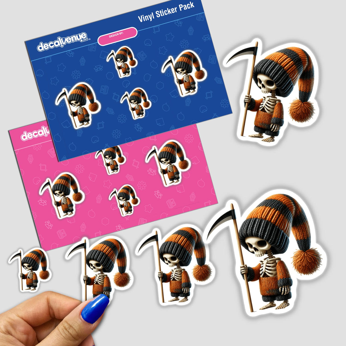 Colorful vinyl stickers depicting a skeleton gnome holding a scythe, displayed on a pink and blue background with the Decal Venue logo. The stickers feature the detailed character design with intricate details and vibrant colors, showcasing the unique digital artwork style from the Decal Venue brand.