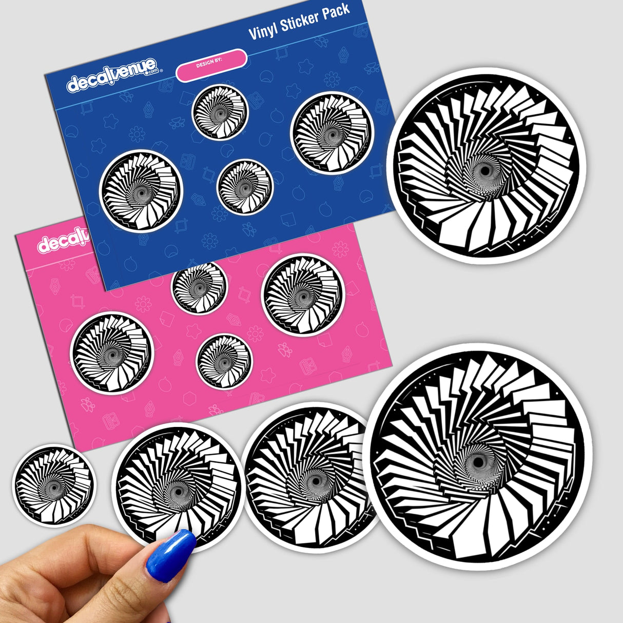 Artistic stickers displaying an infinite staircase optical illusion. The stickers feature a repeating spiral design in black and white, creating a mesmerizing visual effect. The stickers are displayed on a colorful background, showcasing the products offered by Decal Venue, an online store specializing in unique digital artwork and stickers.